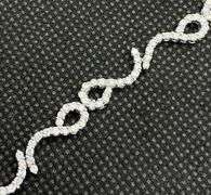 STUNNING 3.50 CARATS T.W. ROUND PAVÉ SET LEO TENNIS BRACELET IN 18K WHITE GOLD