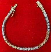 CERTIFIED 14K WHITE AND YELLOW GOLD DIAMOND TENNIS BRACELET. 1.25 CARAT