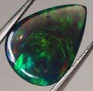 Silky black with blue and green flashing 1.34ct Black Opal cabochon