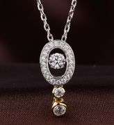 Two tone oval sterling silver and dancing stone pendant