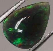 Silky black with blue and green flashing 1.34ct Black Opal cabochon