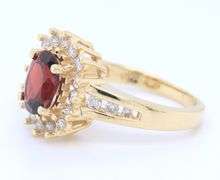 Stunning Yellow Gold Oval Garnet and Diamond Halo Ring