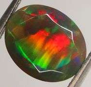 Fully faceted full panel flashing 1.64ct oval cut Black Opal