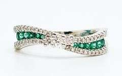Flowing Channel Set 18k White Gold Emerald and Diamond Ring with Triple-Stone Center