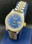 PREOWNED TWO TONE 26MM ROLEX LADIES DATE-JUST ROMAN NUMERALS BLUE DIAL WITH CUSTOM DIAMOND BEZEL| JUBILEE BAND