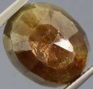 Shimmering metallic 15.64ct earth toned faceted Sapphire