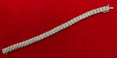 CERTIFIED LADIES 10K WHITE GOLD AND DIAMOND TENNIS BRACELET.