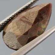 Shimmering metallic 10.84ct earth toned faceted Sapphire