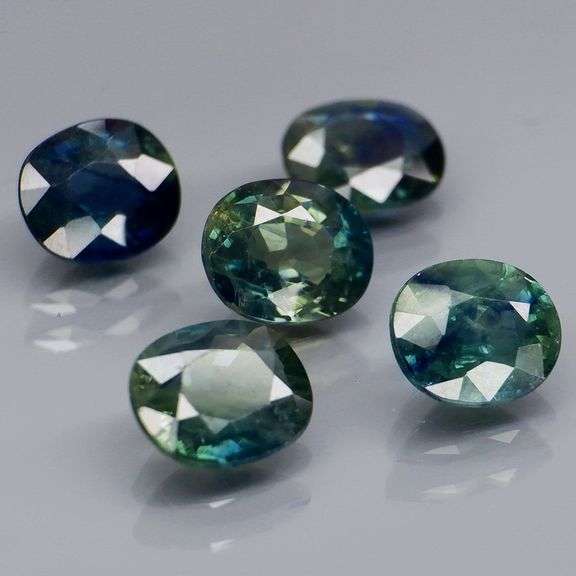 Heated only! 5.03ct blue green Sapphire set