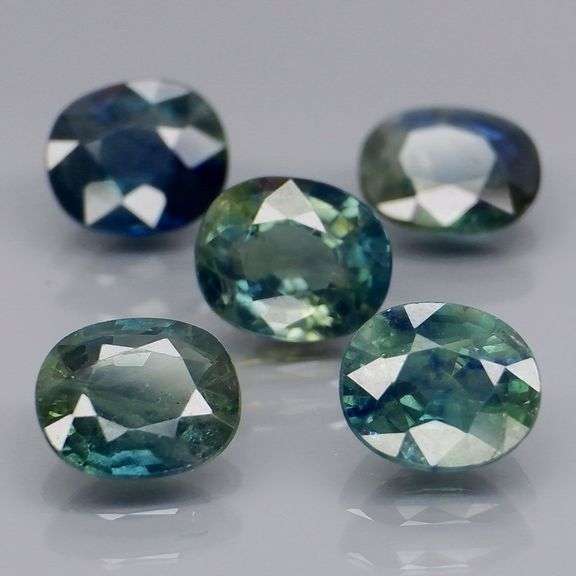 Heated only! 5.03ct blue green Sapphire set