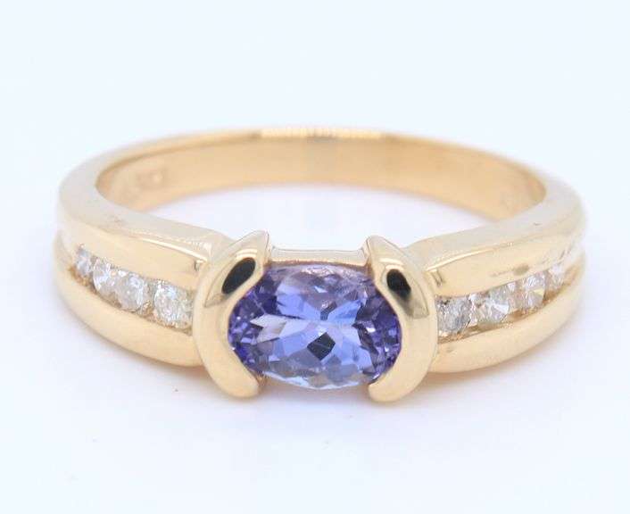 Attractive Yellow Gold oval Tanzanite and Side Channel Set Diamond Ring