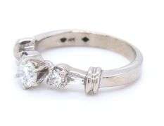Dazzling White Gold Round Brilliant Cut and Tapered Baguette Three Stone Diamond Ring