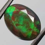 Fully faceted full panel flashing 1.92ct oval cut Black Opal