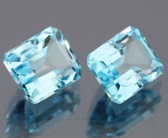 Dazzling 12.85ct vivid blue emerald cut Topaz pair