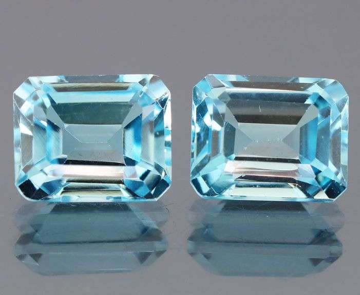 Dazzling 12.85ct vivid blue emerald cut Topaz pair