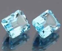 Dazzling 12.85ct vivid blue emerald cut Topaz pair