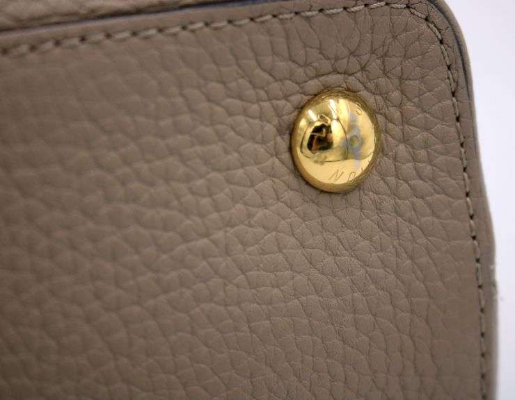 Authentic Louis Vuitton Taurillon calf skin leather in beige Capucines BB Galet handbag
