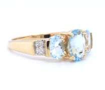 14kt Yellow gold 2ctw oval aquamarine and diamond accent 3 stone ring