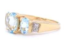 14kt Yellow gold 2ctw oval aquamarine and diamond accent 3 stone ring