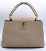 Authentic Louis Vuitton Taurillon calf skin leather in beige Capucines BB Galet handbag