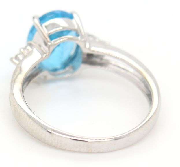 14kt White gold oval blue topaz and diamond open shank ring