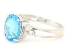 14kt White gold oval blue topaz and diamond open shank ring