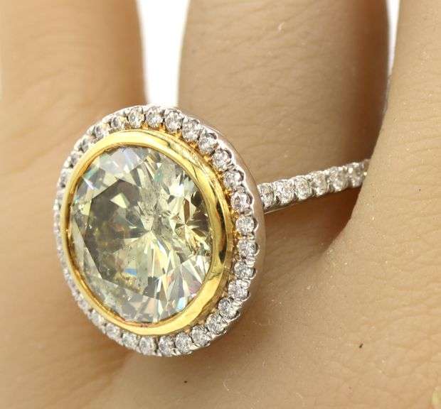 18kt White gold 8.34ct Enhanced GIA yellow diamond in halo setting