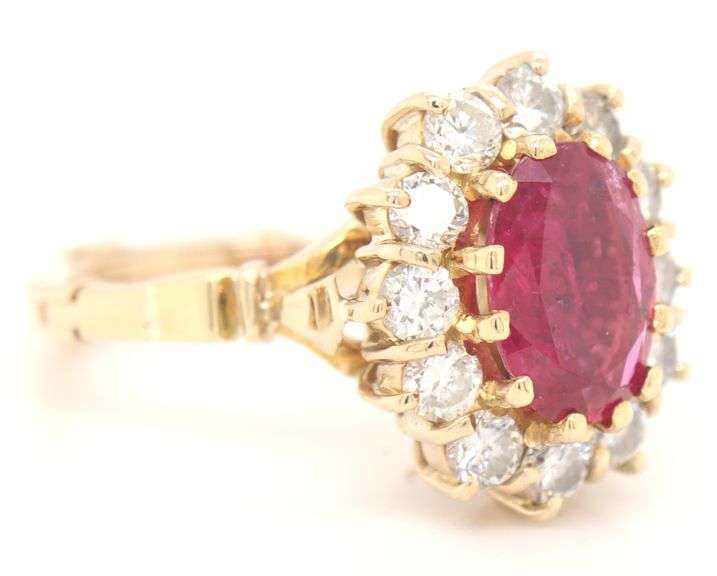 14kt Yellow gold oval ruby and diamond halo ring