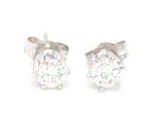 One pair of 14kt White gold round brilliant cut diamond stud earrings