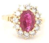 14kt Yellow gold oval ruby and diamond halo ring