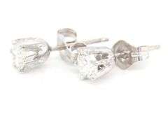 One pair of 14kt White gold round brilliant cut diamond stud earrings