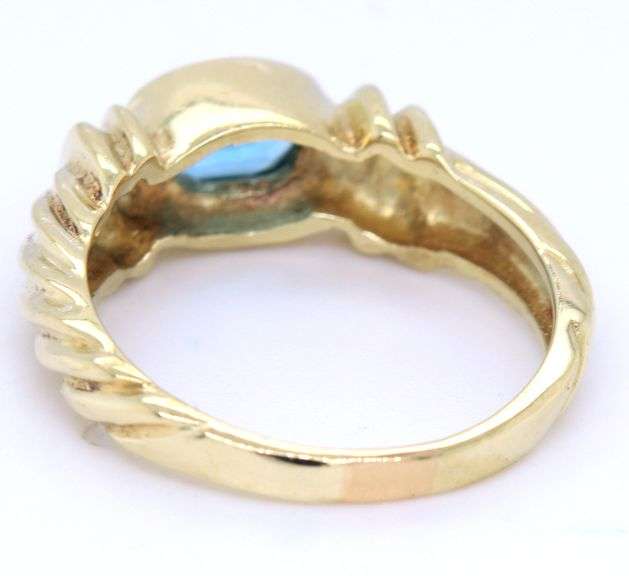 14kt Yellow gold Bezel set oval blue topaz twisted ring