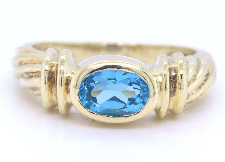 14kt Yellow gold Bezel set oval blue topaz twisted ring