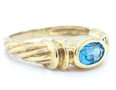14kt Yellow gold Bezel set oval blue topaz twisted ring
