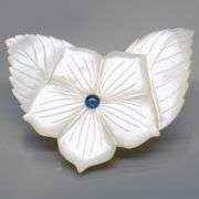 Shimmering 43.06ct flower Mother of Pearl carving with Sapphire