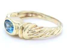 14kt Yellow gold Bezel set oval blue topaz twisted ring