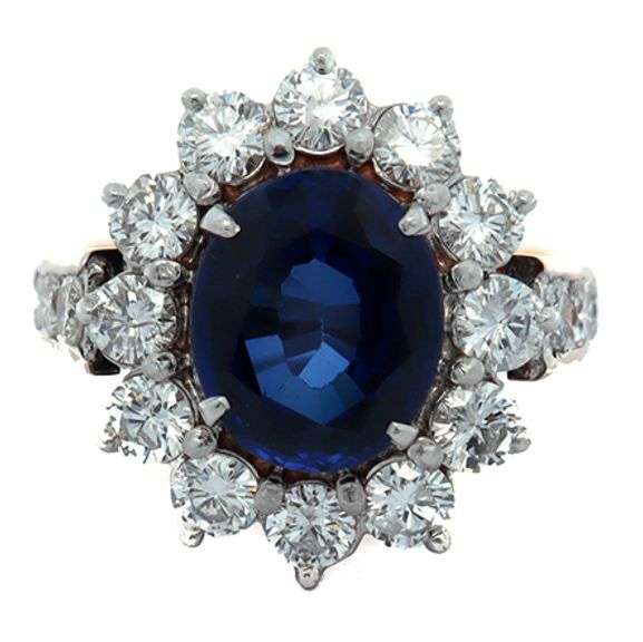 4.49ct Oval Sapphire and 1.50ctw Diamond Starburst Frame Ring in 18K