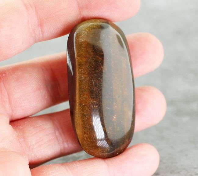 Dramatic 128.44ct Tiger Eye cabochon