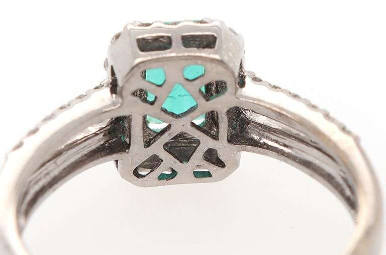 1.00ct Emerald and 0.50ct Diamond Halo Ring in 18K