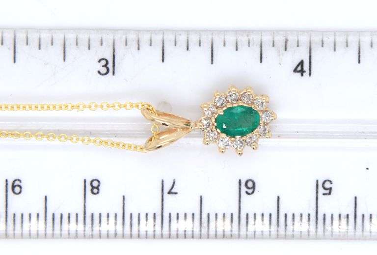 14kt Yellow gold oval Emerald and diamond halo pendant on chain necklace