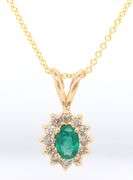 14kt Yellow gold oval Emerald and diamond halo pendant on chain necklace