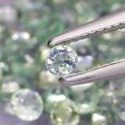Heated only! 5.43ct round cut green Sapphire set