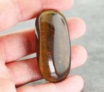 Dramatic 128.44ct Tiger Eye cabochon