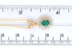 14kt Yellow gold oval Emerald and diamond halo pendant on chain necklace