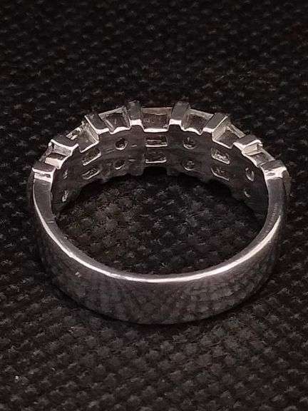 A RADIANT PLATINUM RING WITH BAGUETTES AND PRINCESS CUTS