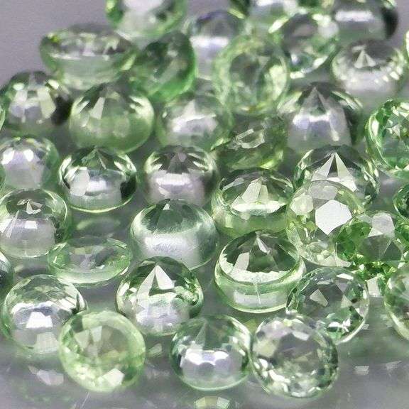 Awesome 5.54ct diamond cut green Sapphire set