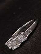 A GLEAMING 14K WHITE GOLD RING WITH PRINCESS CUT DIAMONDS