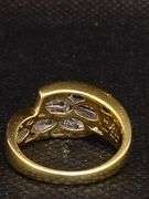 A STUNNING 14K SOLID YELLOW GOLD RING WITH PRINCESS CUTS AND BAGUETTES