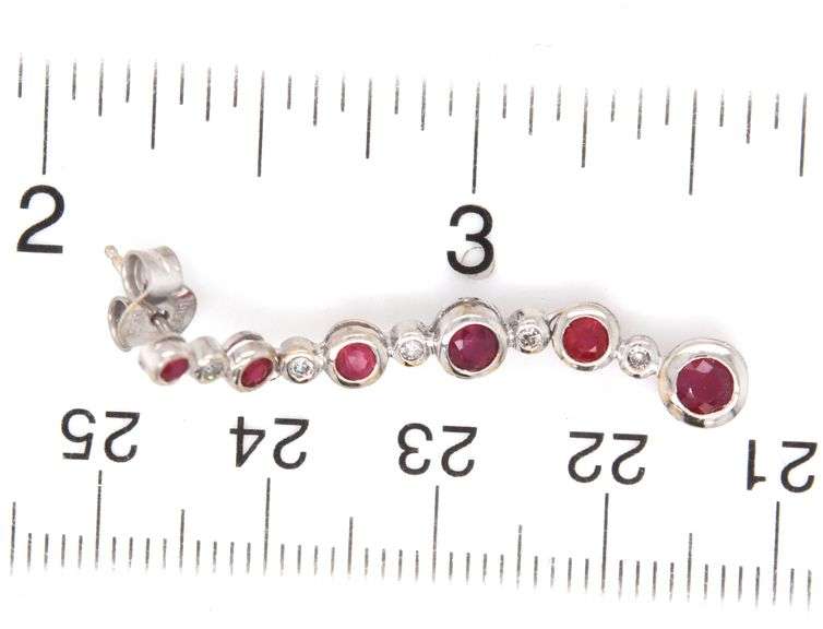 14kt White gold 1.25ctw bezel set ruby and diamond dangle earrings
