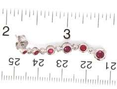 14kt White gold 1.25ctw bezel set ruby and diamond dangle earrings